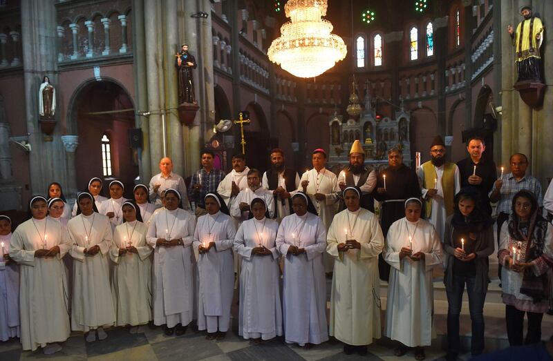 Pakistani Christians and Muslims hold candles at a tribute to bomb blast victims at the Sacred Heart Cathedral Church in Lahore. AFP