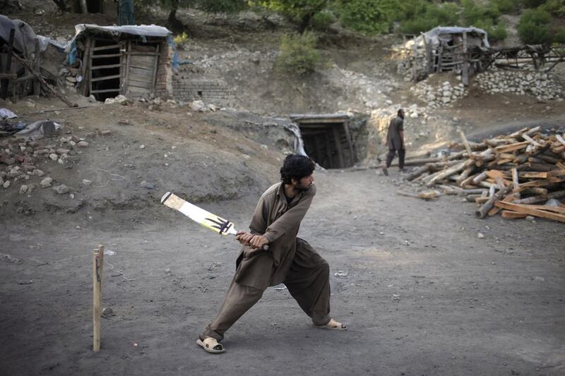 A miner plays cricket in the evening at a coal field in Choa Saidan Shah, Punjab. Sara Farid / Reuters