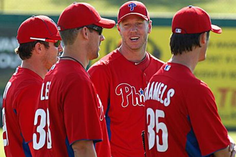 Chase Utley, far left, could miss a significant portion of the first half of the season due to a troublesome knee, but the addition of Cliff Lee, second from the left, to a starting five rotation that already includes Roy Halladay, centre, and Cole Hamels, right, should keep the Phillies atop the NL East regardless.