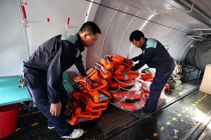 Officials inspect life jackets inside a Vietnamese Air Force plane before a search and rescue operation. Luong Thai Linh / EPA March 10