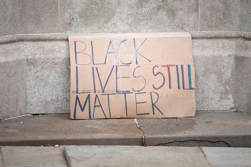 BRISTOL, ENGLAND - JULY 15: A close-up of a sign which says "Black Lives Still Matter" on the Edward Colston statue plinth on July 15, 2020 in Bristol, England. A statue of slave trader Edward Colston was pulled down and thrown into Bristol Harbour during Black Lives Matter protests sparked by the death of an African American man, George Floyd, while in the custody of Minneapolis police in the United States of America. The Mayor of Bristol has since announced the setting up of a commission of historians and academics to reassess Bristol's landmarks and buildings that feature the name of Colston and others who made fortunes in trades linked to slavery. (Photo by Matthew Horwood/Getty Images)