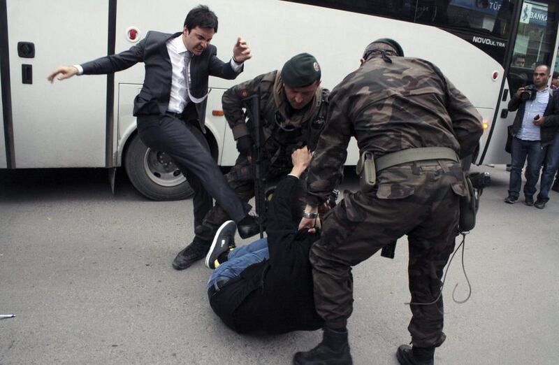 Turkish newspapers Cumhuriyet and Milliyet printed photographs they said were of Mr Erdogan’s aide, Yusuf Yerkel, kicking a protester who was on the ground and being held by special forces police. Depo Photos/AFP Photo