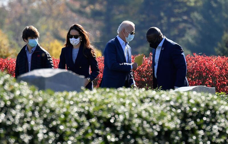 President-elect Joe Biden and his daughter Ashley Biden leave after visiting their family grave at St. Joseph on the Brandywine Roman Catholic Church in Wilmington, Delaware.  AFP