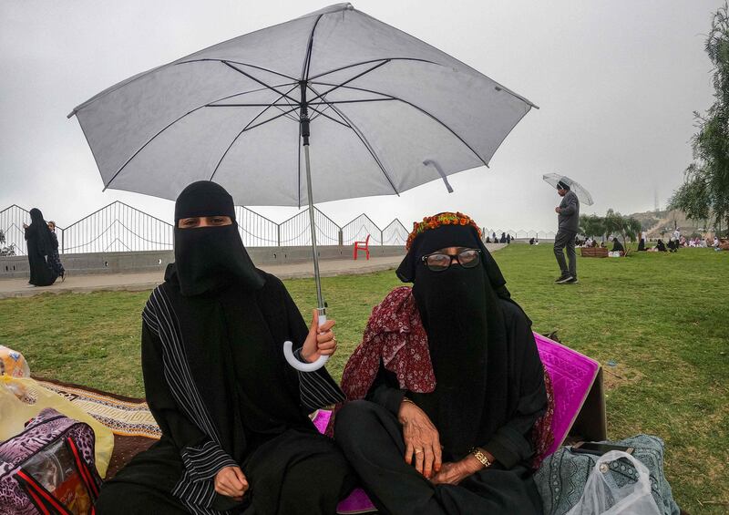 Holidaymakers – some of whom have driven 12 hours from Riyadh to escape the heat – in raincoats and woolly hats.