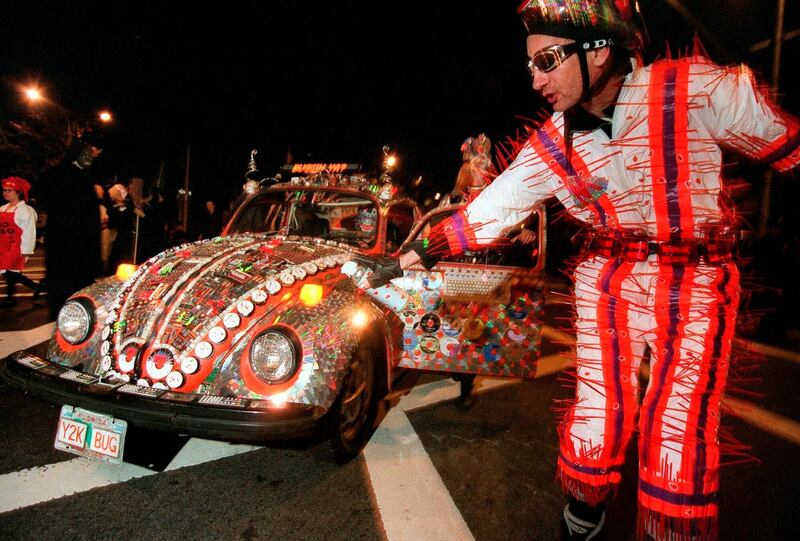 Dick Darling, of the Manhattan borough of New York, rollerblades in front of a 1974 Beetle named Y2K Bug during the annual Greenwich Village Halloween parade. AP Photo