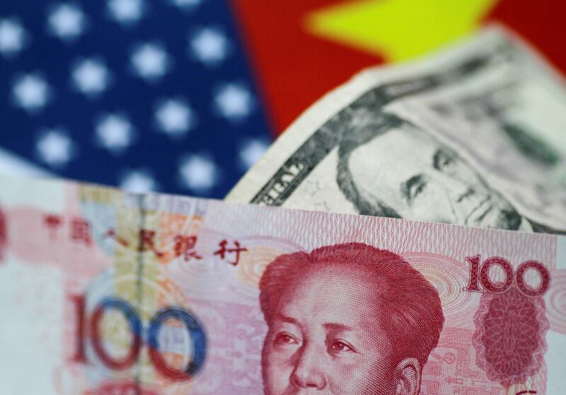 FILE PHOTO: U.S. Dollar and China Yuan notes are seen in this picture illustration June 2, 2017. REUTERS/Thomas White/Illustration/File Photo