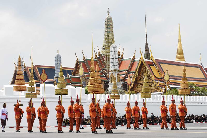 Attendants take part in the funeral procession for the late Thai king Bhumibol Adulyadej in Bangkok.
A sea of black-clad mourners massed across Bangkok's historic heart early as funeral rituals began for the Thai King, a revered monarch whose passing after a seven-decade reign has left Thailand bereft of its only unifying figure.  Anthony Wallace / AFP.