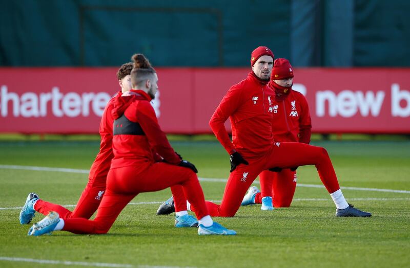 Jordan Henderson with teammates during training. A defeat for Liverpool and win for Napoli could see Liverpool go out of the Champions League. Reuters