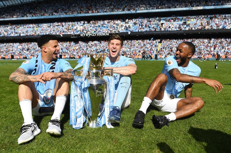 Kyle Walker, John Stones and Raheem Sterling celebrate winning the Premier League title. Michael Regan / Getty Images