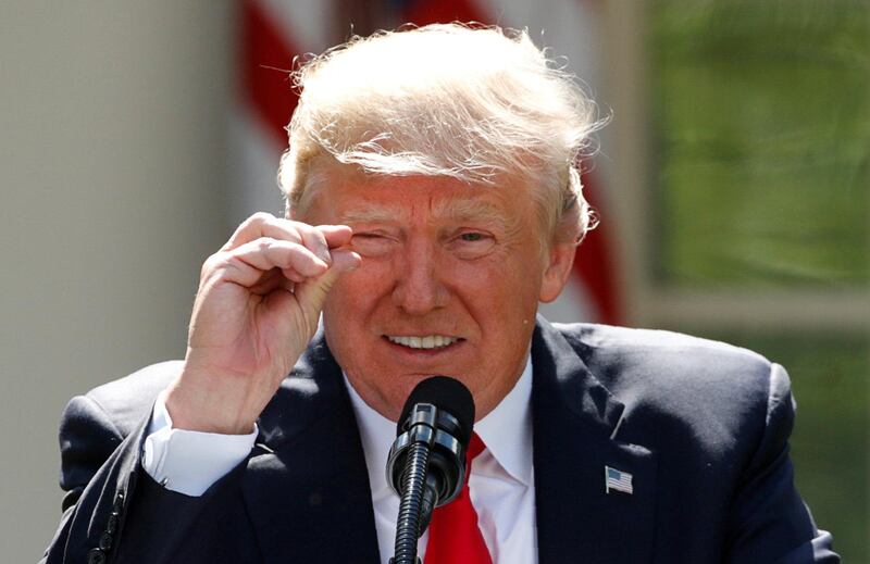 FILE PHOTO: U.S. President Donald Trump refers to amounts of temperature change as he announces his decision that the United States will withdraw from the landmark Paris Climate Agreement, at the White House in Washington, U.S., June 1, 2017. REUTERS/Kevin Lamarque/File Photo