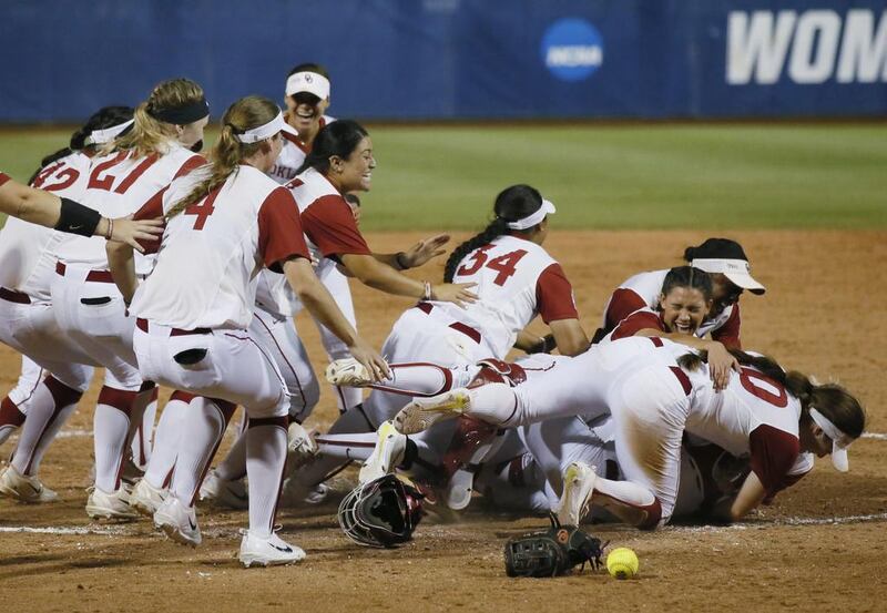 The Oklahoma softball team celebrates defeating Florida to clinch the NCAA Women’s College World Series in Oklahoma City. Sue Ogrocki / AP Photo