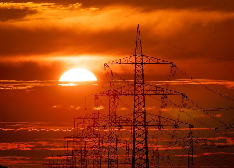 The sun rises behind power poles in Frankfurt, Germany.  AP