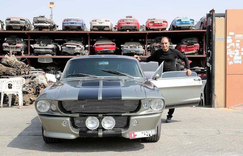 SHARJAH , UNITED ARAB EMIRATES ,  October 29 , 2018 :- Sheikh Imran Rashid , owner of the Rayans Rides car workshop with the Ford Mustang Eleanor 1967 model outside one of the car scrap shop at Emirates Industrial City in Sharjah. ( Pawan Singh / The National )  For Motoring. Story by Adam 