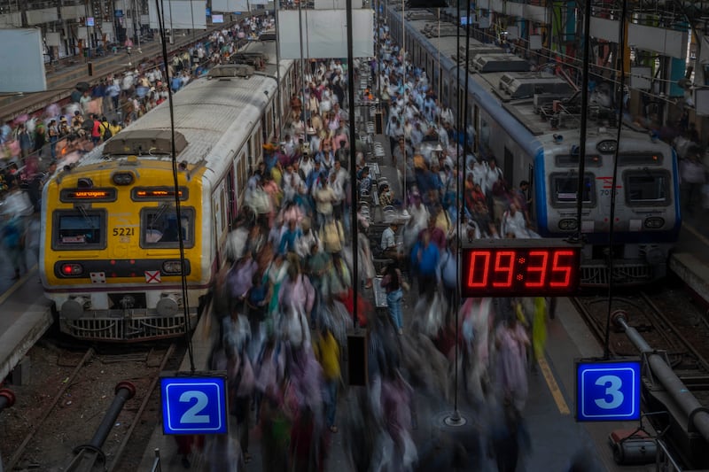 Indian commuters get off trains at the Church Gate railway station in Mumbai, India. AP