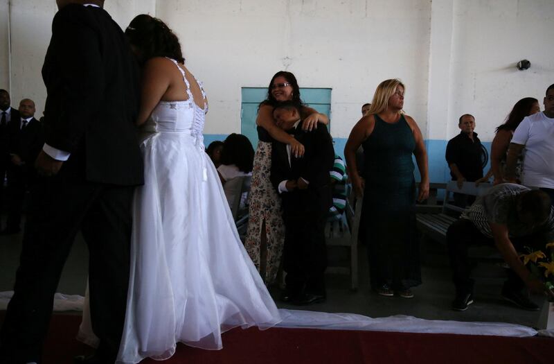 A boy reacts as his parents attend their community wedding organized by Coracao Solidario (Solidarity Heart) at the male prison Lemos de Brito at Bangu, largest prison complex in Rio de Janeiro, Brazil December 18, 2017. REUTERS/Pilar Olivares