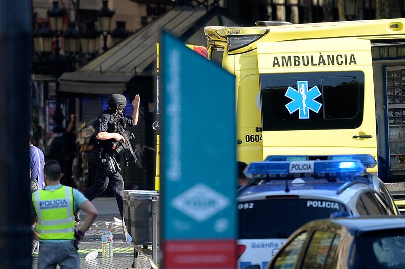 An armed policeman arrives in the area. Police were clearing the area after the attack, which has left a number of people injured. Josep Lago / AFP.