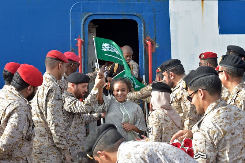 Members of the Saudi Navy assist evacuees. AFP