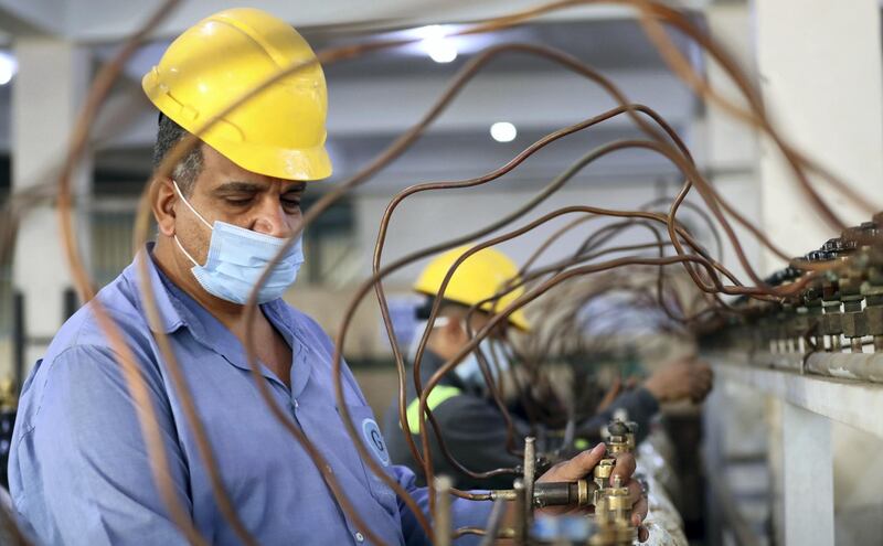 epa08921717 Worker fills oxygen cylinders in a Gulf Gases factory in Cairo, Egypt, 05 January 2021 (issued 06 January 2021). Egyptâ€™s health ministry affirmed the availability of oxygen in sufficient quantities at all hospitals receiving coronavirus patients nationwide, after reports claimed six patients with Covid19 died allegedly due to the lack of oxygen in two public hospitals in Sharqiya and Gharbiya governorates.  EPA/KHALED ELFIQI