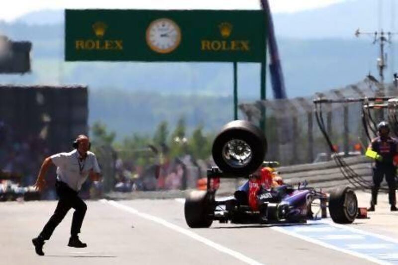 A crewman reacts as a tyre from Mark Webber’s Red Bull Racing goes flying while he was leaving his pit box during the German Grand Prix at Nurburgring. The tyre struck a cameraman, sending him to hospital.