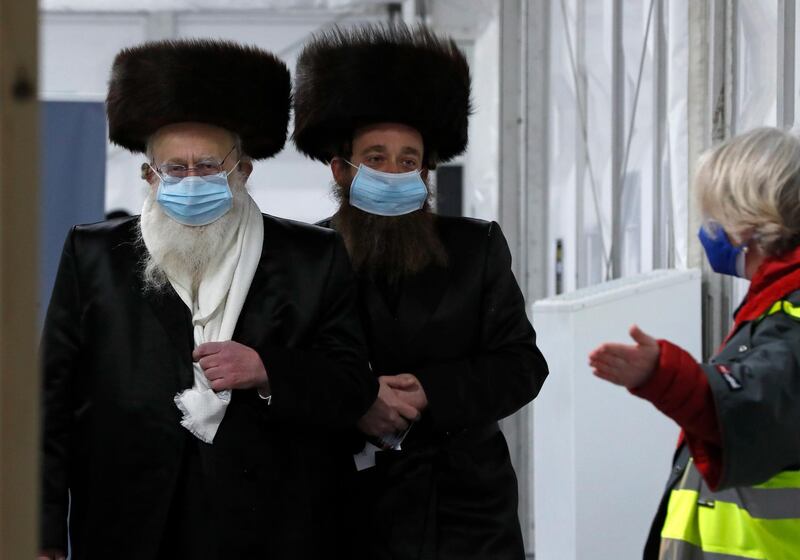 Two men from the Haredi Orthodox Jewish community at an event to encourage vaccine uptake in Britain's Haredi community at the John Scott Vaccination Centre in London, February 13. AP