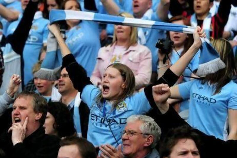 Manchester City fans celebrate after the last-gasp glory was secured.