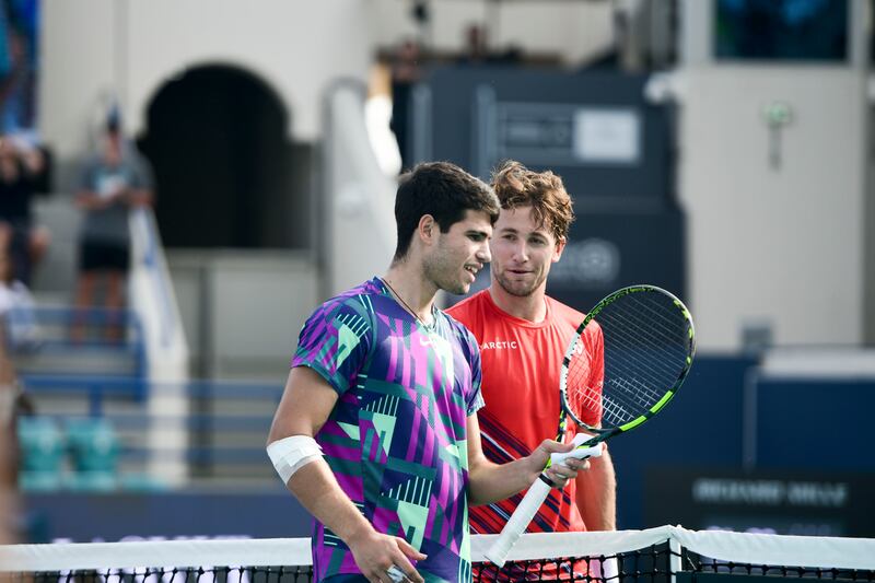 Carlos Alcaraz, left, and Casper Ruud greet each other at the net following their third-place playoff match at the Mubadala World Tennis Championships held in Zayed Sports City, Abu Dhabi. Khushnum Bhandari / The National
