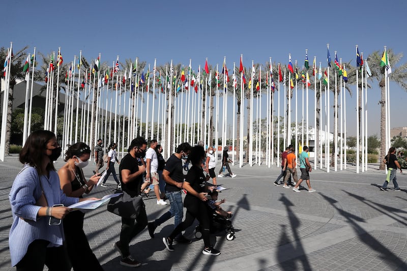 Visitors check maps to plan their visit at the Expo 2020 site in Dubai. Pawan Singh / The National