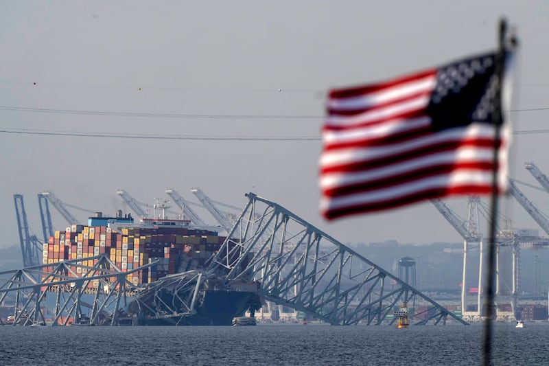 The container ship Dali rests against the wreckage of the Francis Scott Key Bridge in Baltimore, Maryland on Tuesday. The incident 
looks set have a cascade effect on jobs, businesses, trade and transport not just in the US north-east, but internationally. AP