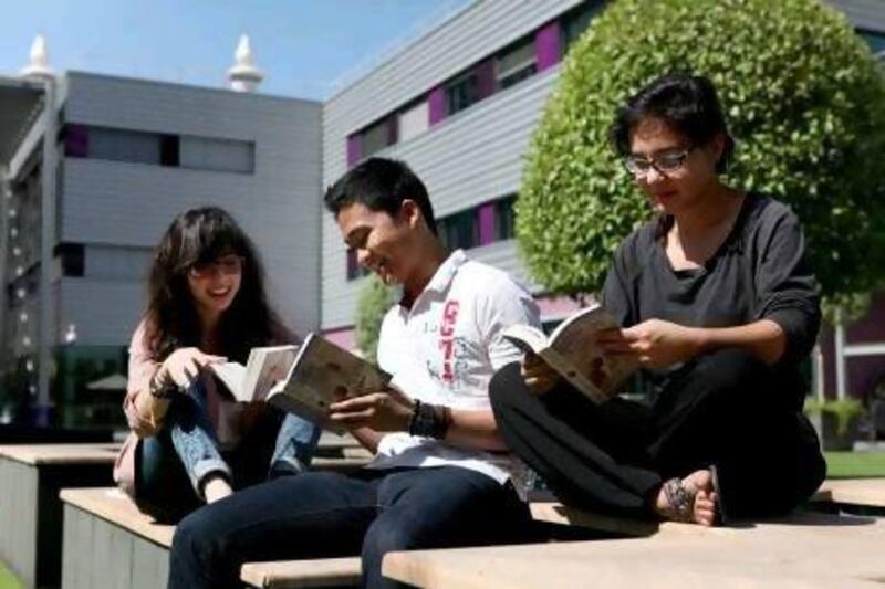 Students from the New York University Abu Dhabi read outside in a campus courtyard. Fatima Al Marzooqi / The National