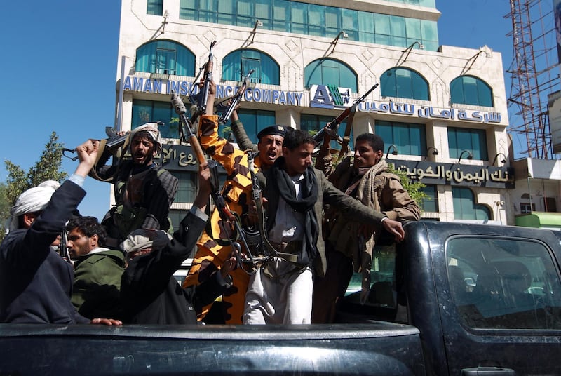 (FILES) In this file photo taken on February 11, 2015 Shiite Huthi fighters shout slogans as they ride the back of a pick up in the Yemeni capital Sanaa. - UN launches new talks on September 3, 2018, in Geneva to end the "dirty war" in Yemen, a forgotten conflict causing the worst humanitarian crisis in the world. But an agreement seems far away such the animosity between belligerents is huge. (Photo by MOHAMMED HUWAIS / AFP)