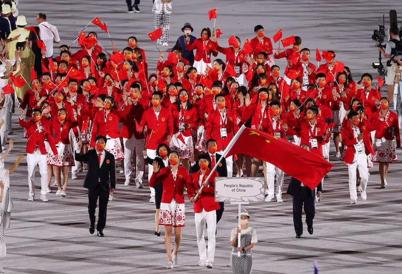 Flag Bearers of People's Republic of China Ting Zhu and Shuai Zhao lead a delegation during the Opening Ceremony.