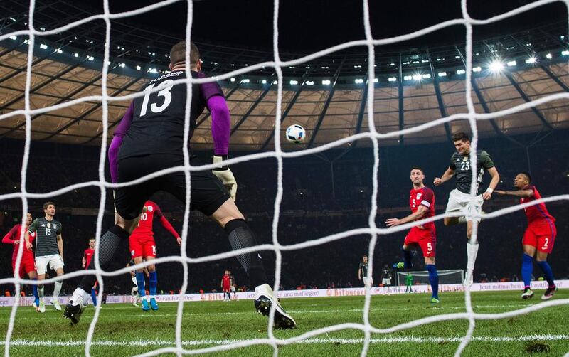 Germany’s forward Mario Gomes (2nd R) heads past England’s goalkeeper Fraser Forster to score his side’s 2nd goal during the friendly football match Germany v England at the Olympic stadium in Berlin on March 26, 2016. AFP / ODD ANDERSEN