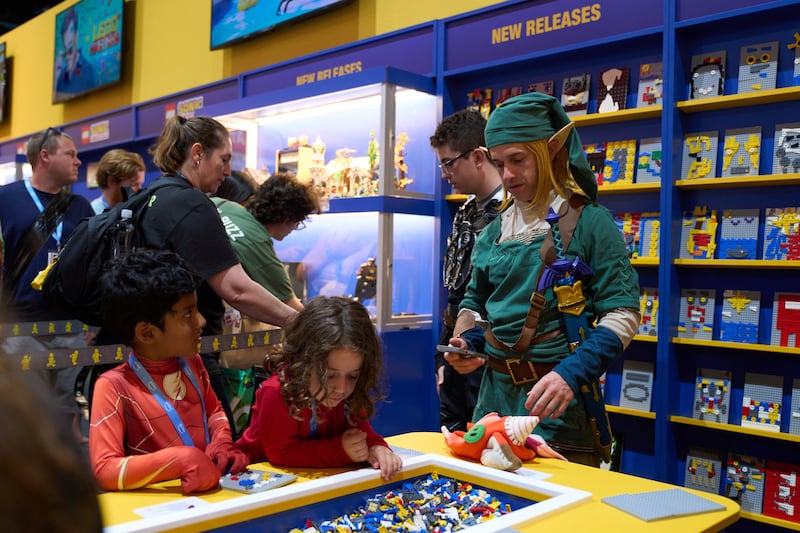 Fans play with Lego at the Lego Brickbuster Video pop-up. EPA 