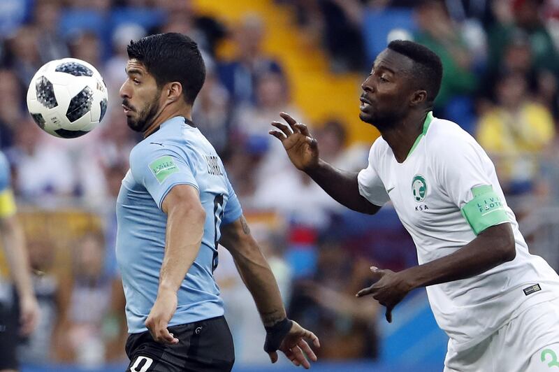 Osama Hawsawi of Saudi Arabia, right, and Luis Suarez of Uruguay in action. Shawn Thew / EPA