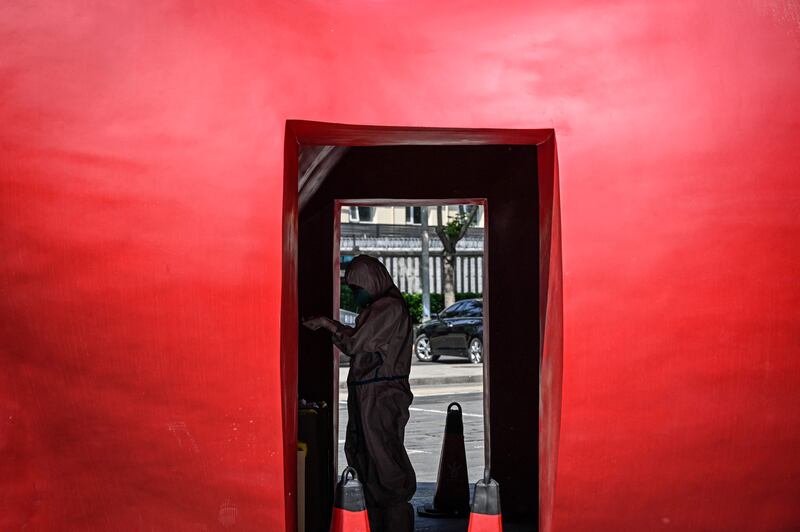A health worker at a makeshift testing centre outside a museum in Beijing. AFP