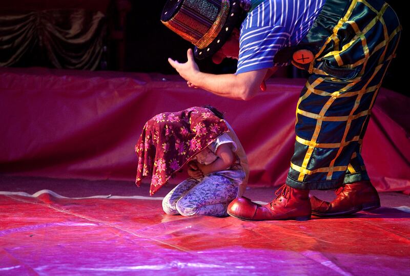 Abu Dhabi, United Arab Emirates, April 29, 2013: 
A young girl patiently participates in a clown's prank during the performance at the Monte Carlo circus on Monday, April 29, 2013, at the circus new temporary location in Mussafah, an industrial subsection of Abu Dhabi. 
Silvia Razgova / The National
