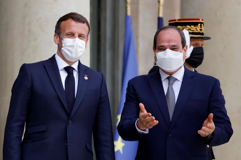 French President Emanuel Macron, left, welcomes Egyptian President Abdel Fattah el-Sissi before attending a video conference with Jordan's King Abdullah II to work on a concrete proposal for a ceasefire and a possible path to discussions between Israel and the Palestinians at the Elysee Palace in Paris, Tuesday, May 18, 2021. Emmanuel Macron called for a cease-fire "as soon as possible," and said France is supporting Egypt's mediation in the conflict as key to avoiding more violence. (Sarah Meyssonnier/Pool via AP)