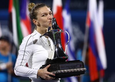 DUBAI, UNITED ARAB EMIRATES - FEBRUARY 22:  Simona Halep of Romania holds the trophy after defeating Elena Rybakina of Kazakhstan during their Women's Singles Final match of the WTA Dubai Duty Free Tennis Championship on Day Six of the Dubai Duty Free Tennis at Dubai Duty Free Tennis Stadium on February 22, 2020 in Dubai, United Arab Emirates. (Photo by Francois Nel/Getty Images)