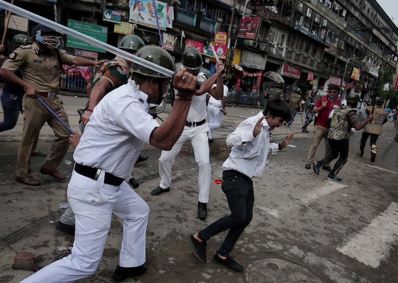 Kolkata police officers charge as hundreds of Bharatiya Janata party (BJP) activists protest against an education recruitment corruption issue in Kolkata, India.  EPA