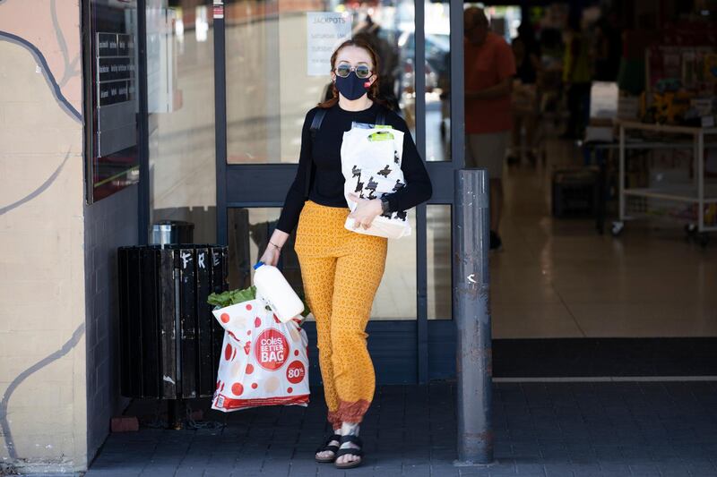 A member of the public is seen wearing a face mask and holding their groceries in Perth, Australia. Getty Images
