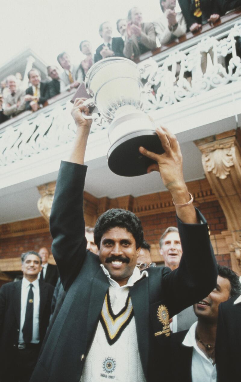 LONDON, UNITED KINGDOM - JUNE 23:  India captain Kapil Dev lifts the trophy on the balcony of the pavillion as Sunil Gavaskar (obscured right) looks on after the 1983 Prudential World Cup Final victory against West Indies at Lords on June 23, 1983 in London, England.  (Photo by Adrian Murrell/Allsport/Getty Images)