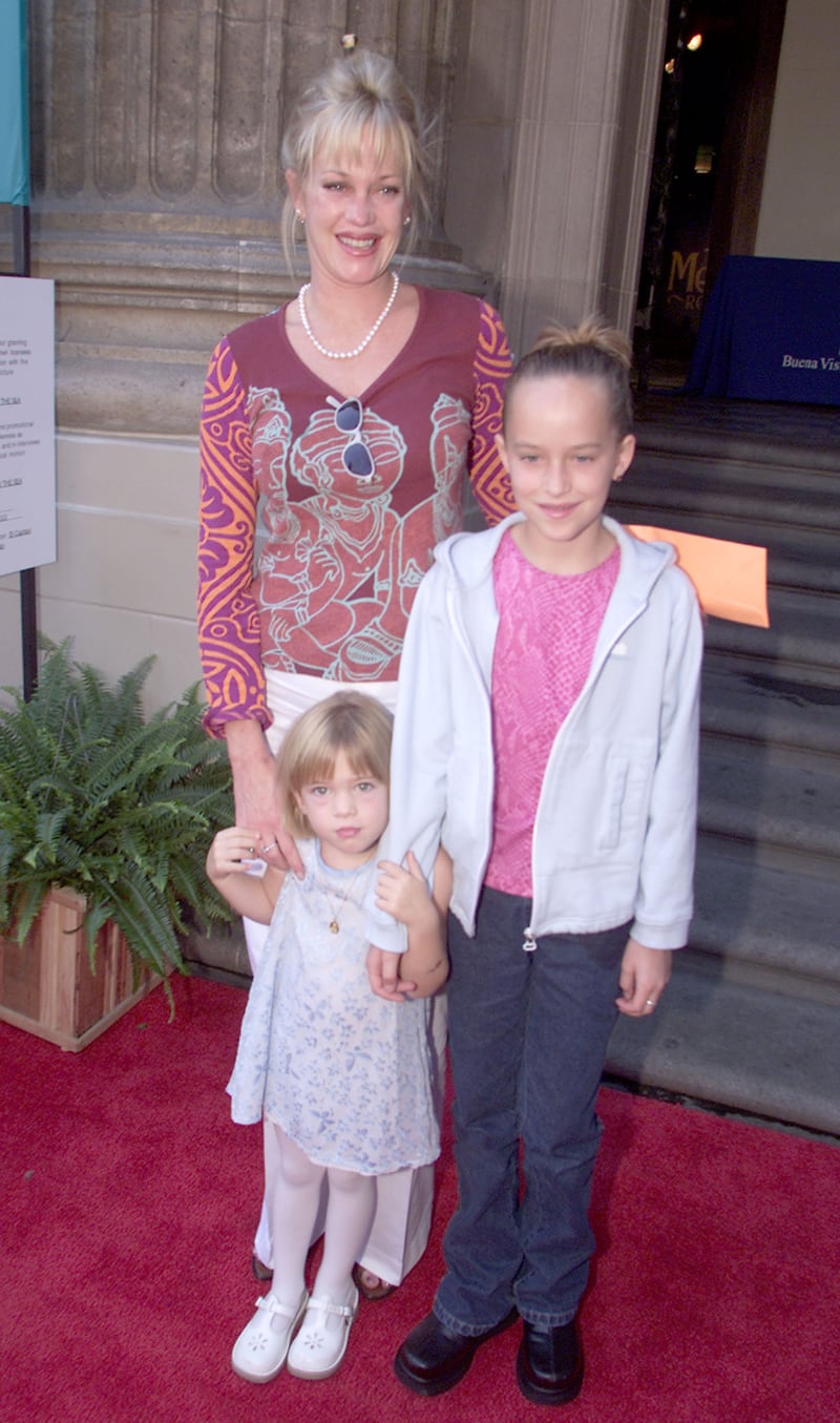 Melanie Griffith, Stella Banderas and Dakota Johnson, in jeans and a pink tee, attend the premiere of 'The Little Mermaid II' in Los Angeles, California, on September 16, 2000. Getty Images