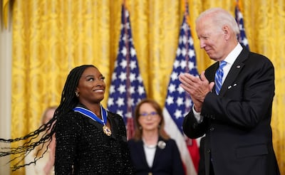 US President Joe Biden applauds after awarding the Presidential Medal of Freedom to US Olympic gymnast Simone Biles. Reuters