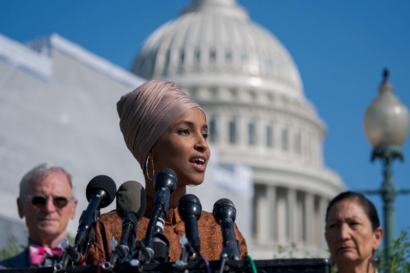 Rep. Ilhan Omar, D-Minn., center, flanked by Rep. Earl Blumenauer, D-Ore., left, and Rep. Deb Haaland, D-N.M., introduces the Zero Waste Act that would create a federal grant program to help local governments invest in waste reduction initiatives, at the Capitol in Washington, Thursday, July 25, 2019. (AP Photo/J. Scott Applewhite)