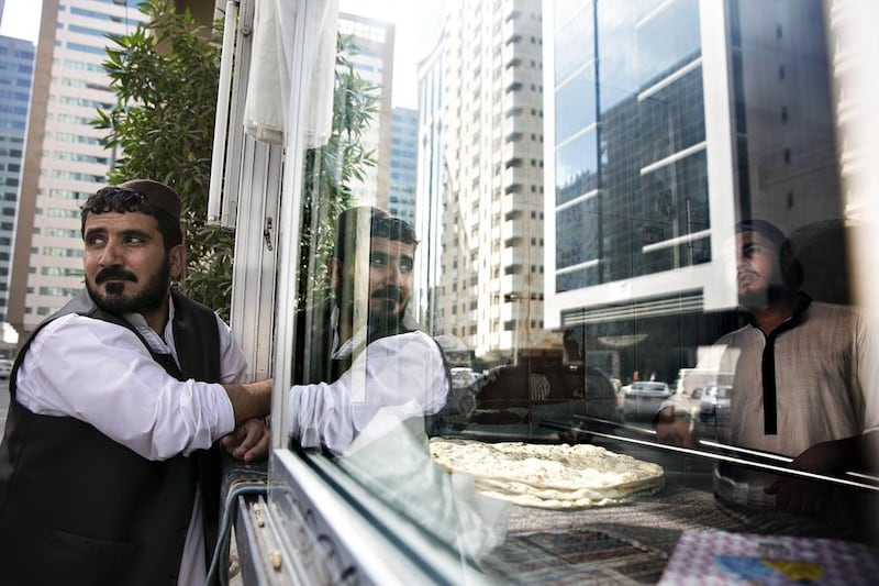 Haji Mohammad, an expatriate from Afghanistan who has baked bread in the Tourist Club district of Abu Dhabi for 17 years, now does so in Al Zahiyah after the municipality changed the area’s name. Zayed City in the capital has also been renamed Al Danah. Silvia Razgova / The National