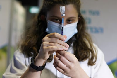 FILE PHOTO: A medical worker prepares to administer a vaccination against the coronavirus disease (COVID-19) at a temporary Clalit healthcare maintenance organisation (HMO) vaccination centre, at a sports arena in Jerusalem February 25, 2021. REUTERS/Ammar Awad/File Photo