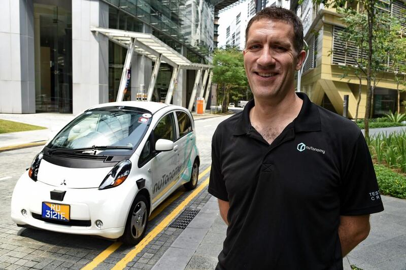 Doug Parker, chief operations officer at US software company nuTonomy, with one of the driverless taxis. Roslan Rahman / AFP