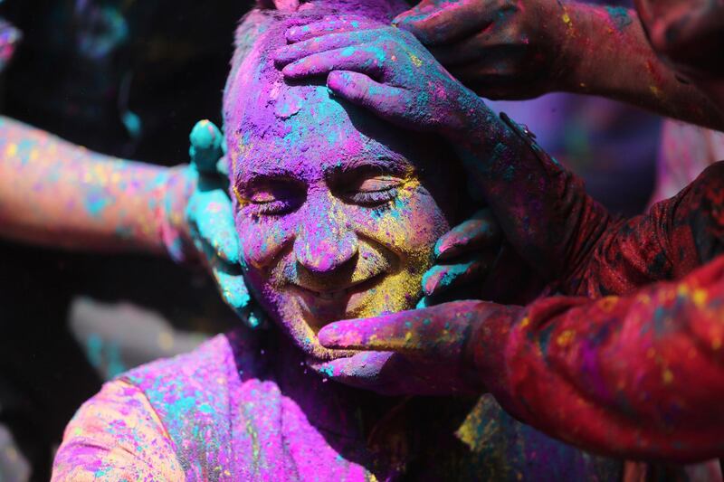 Indians smear colored powder on each other as they celebrate Holi in Jammu, India. Holi, the Hindu festival of colors, also heralds the arrival of spring. AP Photo