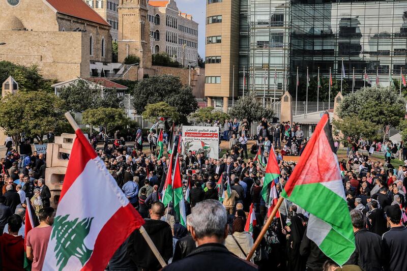 epa07199561 Palestinian and Lebanese wave national flags during a gathering of Lebanese national parties and Palestinian factions to mark the 'International Day of Solidarity with the Palestinian People and Support for the Resistance and Refusal to Normalize', in the Gibran Khalil Gibran Park - in front of the ESCWA building in Beirut, Lebanon, 30 November 2018. The UN General Assembly declared 29 November of each year a day of solidarity with the Palestinian people since 1977, in which it renounced its decision number 181 to partition Palestine, and took into account the legitimate national rights of the Palestinian people, namely, the establishment of an independent Palestinian state and return and self-determination.  EPA/NABIL MOUNZER