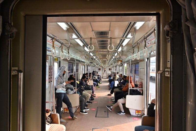 People travel on board a train bounds for Jakarta from Bogor station by applying protocols for the Covid-19 coronavirus in Bogor, Indonesia. AFP